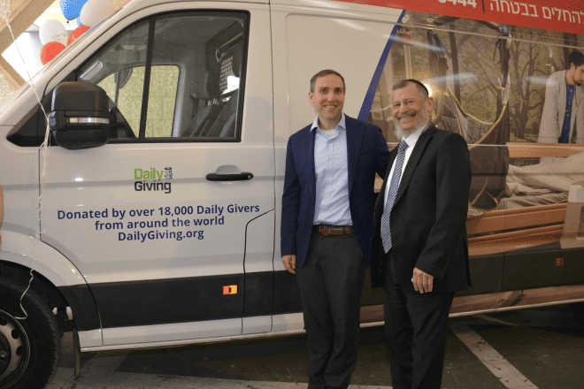 Dr. Jonathan Donath, president of Daily Giving, (left) and Yad Sarah Founder Uri Lupolianski in front of the van purchased using funds donated by Daily Giving. Credit: Courtesy.